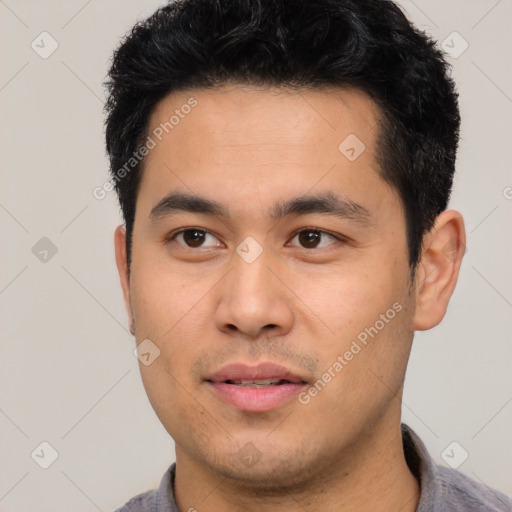 Joyful asian young-adult male with short  black hair and brown eyes