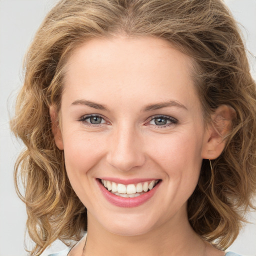 Joyful white young-adult female with long  brown hair and green eyes