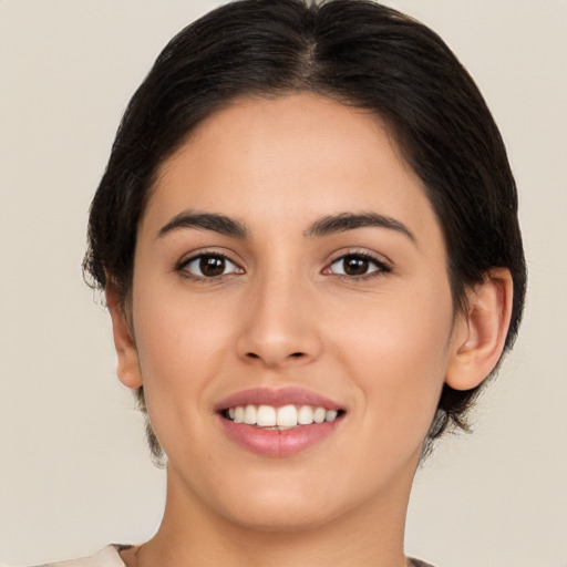 Joyful white young-adult female with medium  brown hair and brown eyes