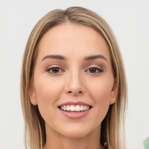 Joyful white young-adult female with long  brown hair and green eyes