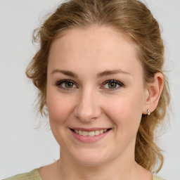 Joyful white young-adult female with medium  brown hair and green eyes