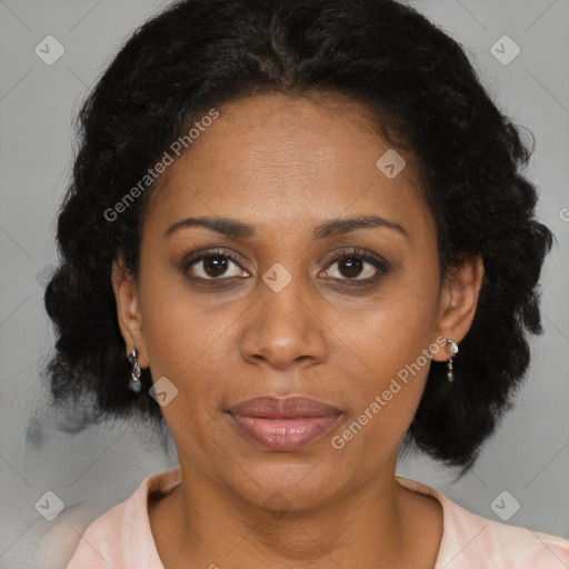 Joyful latino adult female with medium  brown hair and brown eyes