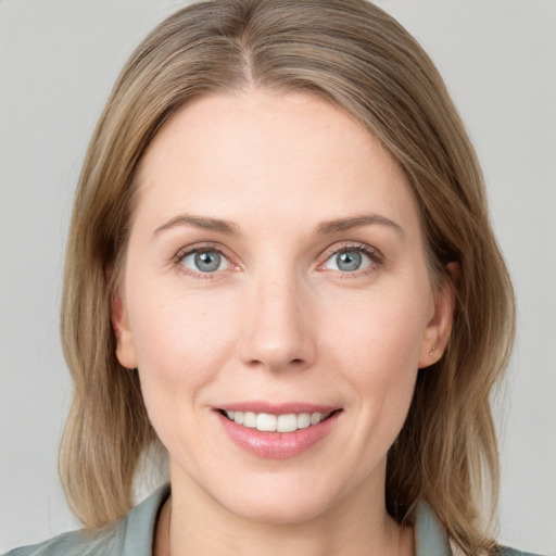 Joyful white young-adult female with medium  brown hair and blue eyes