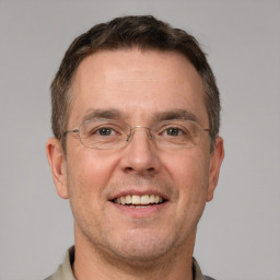 Joyful white adult male with short  brown hair and brown eyes