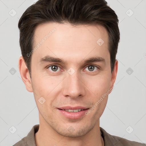 Joyful white young-adult male with short  brown hair and grey eyes