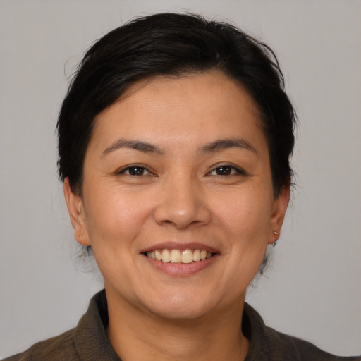 Joyful latino young-adult female with short  brown hair and brown eyes