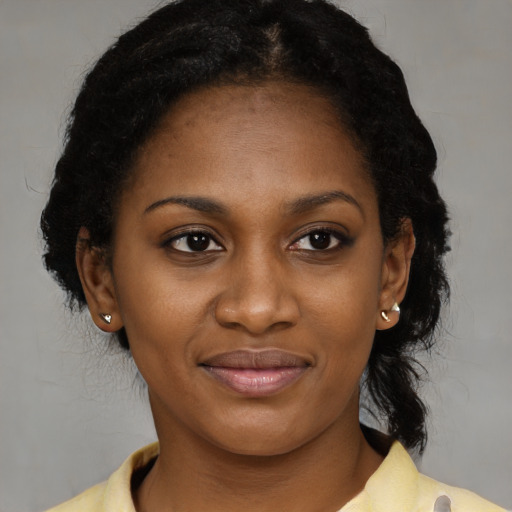 Joyful black young-adult female with medium  brown hair and brown eyes