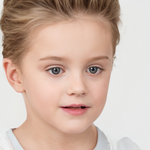 Joyful white child female with short  brown hair and grey eyes