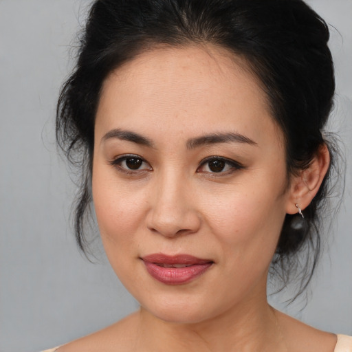 Joyful asian young-adult female with medium  brown hair and brown eyes