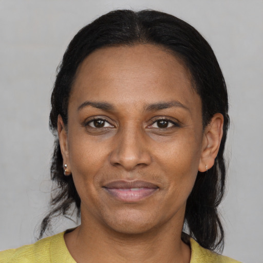 Joyful black adult female with medium  black hair and brown eyes