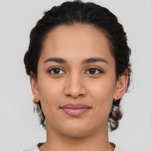 Joyful latino young-adult female with medium  brown hair and brown eyes