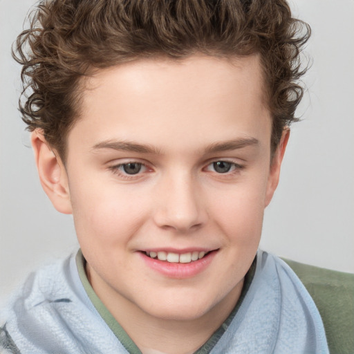 Joyful white child male with short  brown hair and grey eyes