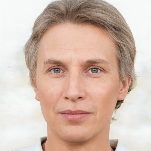 Joyful white adult male with short  brown hair and grey eyes