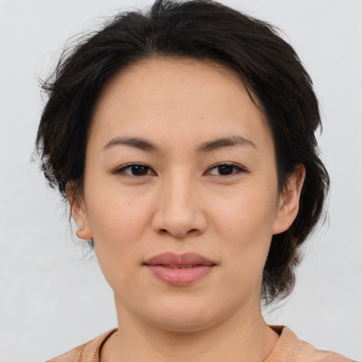 Joyful asian young-adult female with medium  brown hair and brown eyes