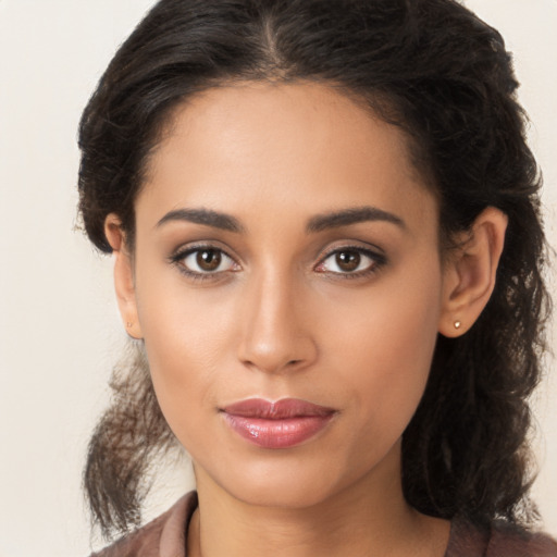 Joyful latino young-adult female with long  brown hair and brown eyes