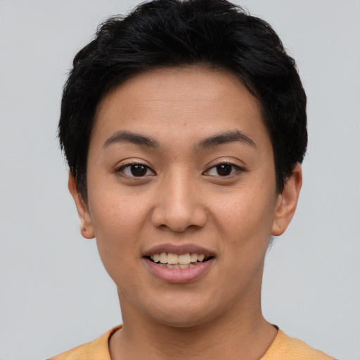 Joyful asian young-adult female with short  black hair and brown eyes
