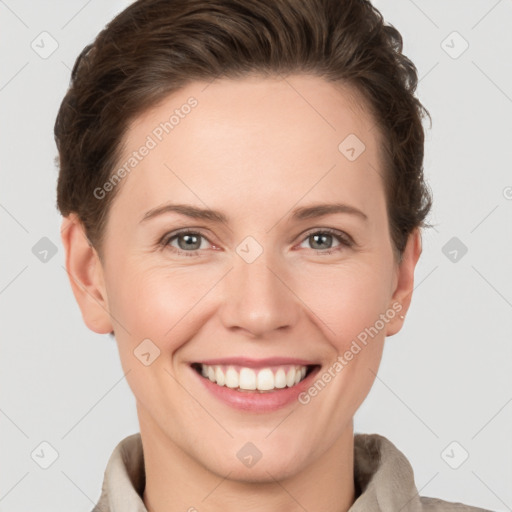 Joyful white young-adult female with short  brown hair and grey eyes