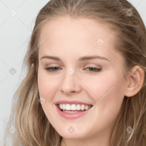 Joyful white young-adult female with long  brown hair and blue eyes