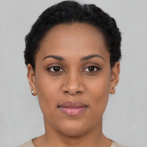 Joyful latino young-adult female with short  black hair and brown eyes