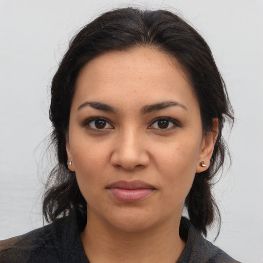 Joyful latino young-adult female with medium  brown hair and brown eyes