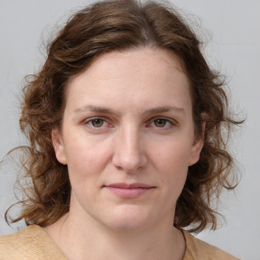 Joyful white young-adult female with medium  brown hair and blue eyes