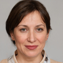 Joyful white adult female with medium  brown hair and brown eyes