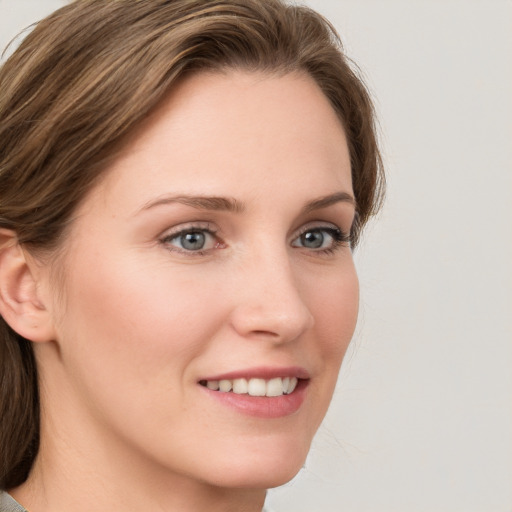 Joyful white young-adult female with medium  brown hair and blue eyes