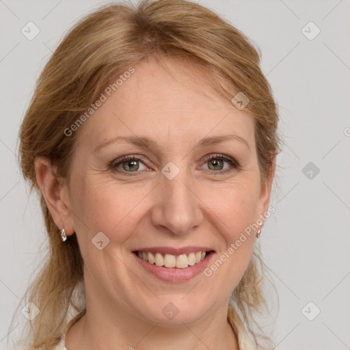 Joyful white adult female with medium  brown hair and grey eyes