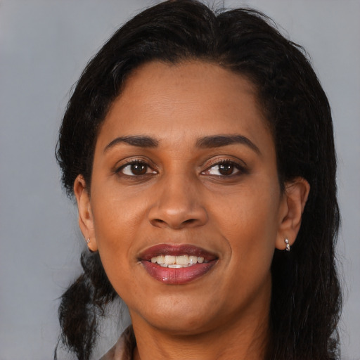 Joyful black young-adult female with medium  brown hair and brown eyes