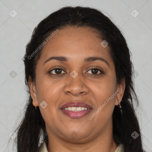 Joyful black adult female with long  brown hair and brown eyes