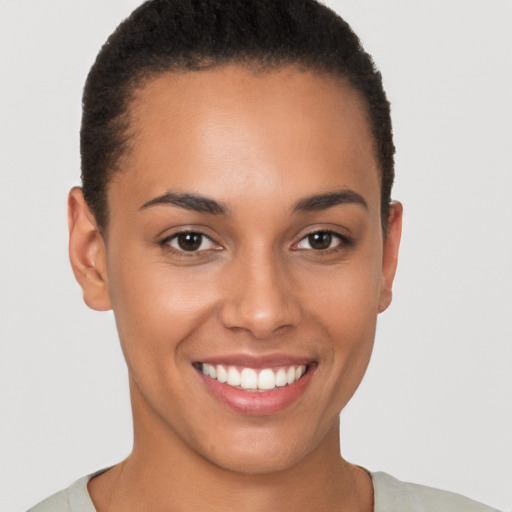 Joyful latino young-adult female with short  brown hair and brown eyes