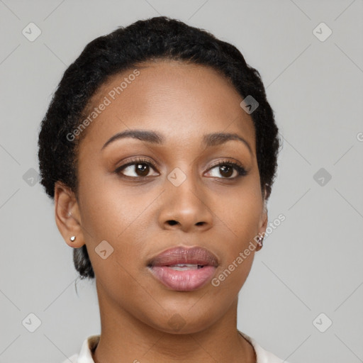 Joyful black young-adult female with short  black hair and brown eyes