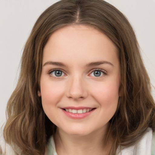 Joyful white young-adult female with long  brown hair and green eyes