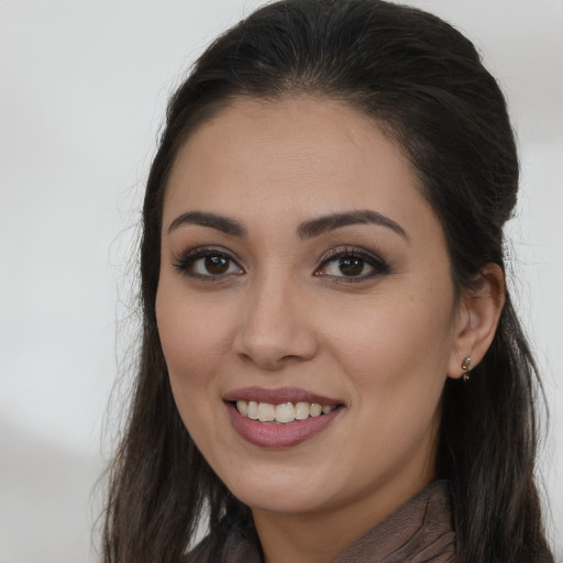 Joyful white young-adult female with long  brown hair and brown eyes