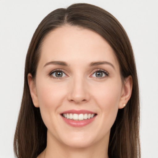 Joyful white young-adult female with long  brown hair and grey eyes