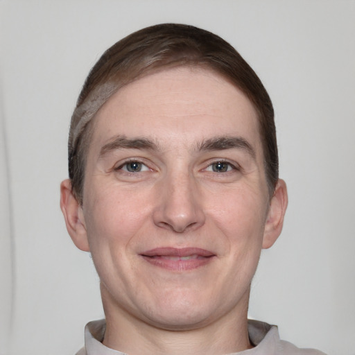 Joyful white adult male with short  brown hair and grey eyes