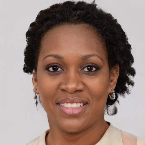 Joyful black adult female with short  brown hair and brown eyes