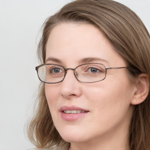 Joyful white young-adult female with long  brown hair and blue eyes