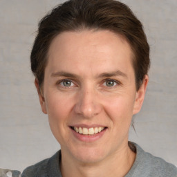 Joyful white adult male with short  brown hair and grey eyes