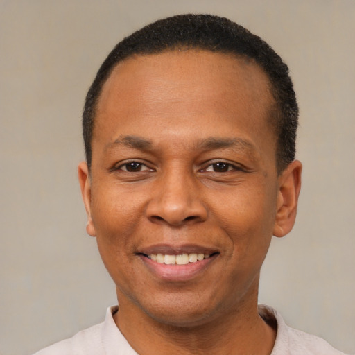 Joyful latino adult male with short  black hair and brown eyes