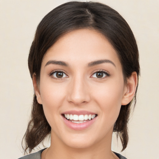 Joyful white young-adult female with medium  brown hair and brown eyes