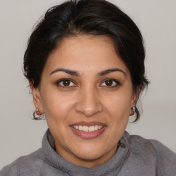 Joyful white adult female with medium  brown hair and brown eyes