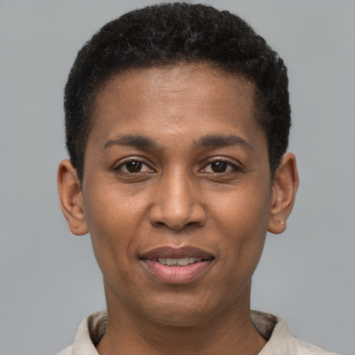 Joyful black young-adult male with short  brown hair and brown eyes