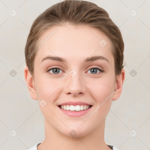 Joyful white young-adult female with short  brown hair and grey eyes