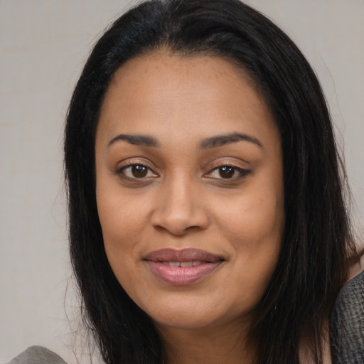 Joyful latino young-adult female with long  black hair and brown eyes