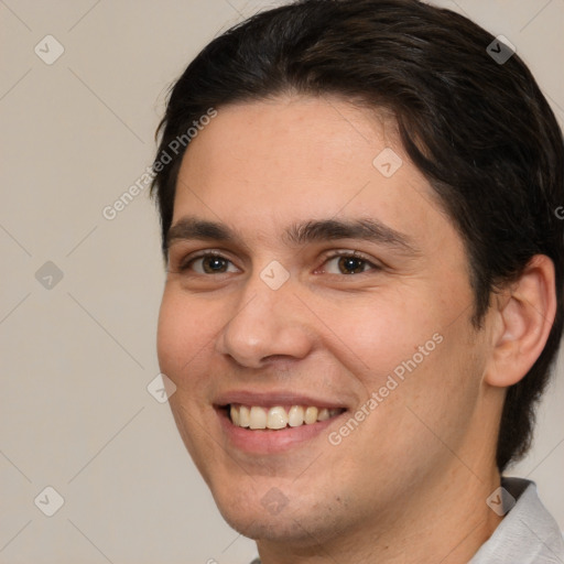 Joyful white young-adult male with medium  brown hair and brown eyes