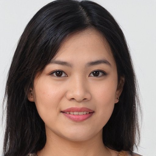 Joyful asian young-adult female with long  brown hair and brown eyes