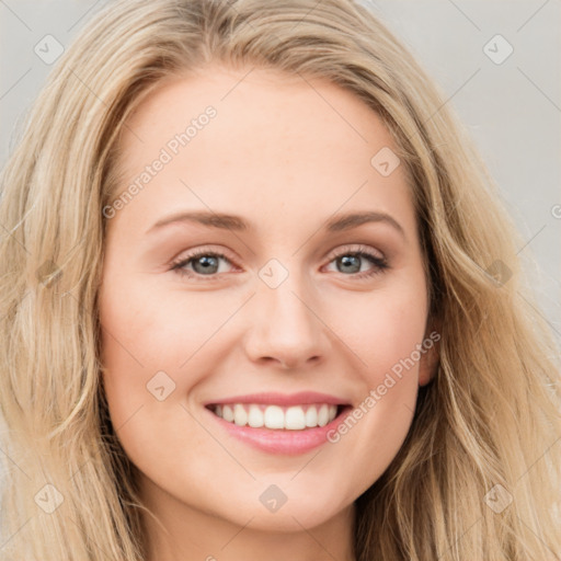 Joyful white young-adult female with long  brown hair and blue eyes