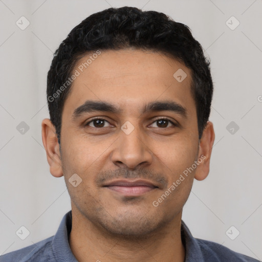 Joyful latino young-adult male with short  black hair and brown eyes