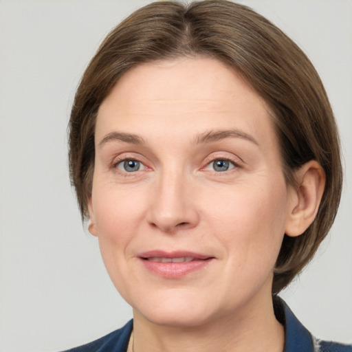 Joyful white adult female with medium  brown hair and grey eyes